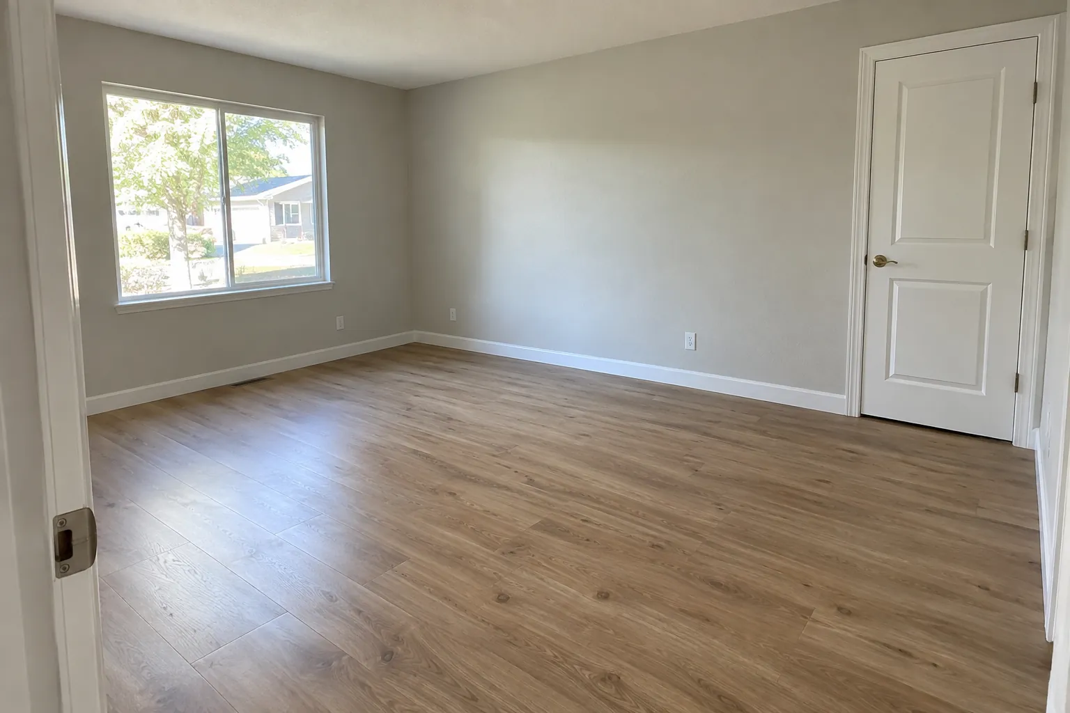 Living room at move-in: the wall beside the bedroom door is clean.